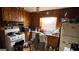 Kitchen featuring dated wood paneling, older appliances, and cluttered surfaces, needing renovation at 2234 Glendale Dr, Decatur, GA 30032