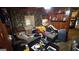 Cluttered living room with wood paneling, a sofa piled with clothes, and various items scattered around at 2234 Glendale Dr, Decatur, GA 30032