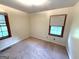 A cozy bedroom featuring neutral carpet, cream walls, and two well-lit windows at 359 Keys Ferry St, Mcdonough, GA 30253