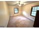 Simple bedroom featuring neutral walls, carpet flooring, and natural light from the two windows at 359 Keys Ferry St, Mcdonough, GA 30253