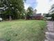 Charming red brick house with green awnings and a sprawling lawn, bordered by mature trees at 359 Keys Ferry St, Mcdonough, GA 30253