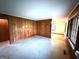Spacious living room featuring wood paneling, neutral carpeting, and ample natural light from the windows at 359 Keys Ferry St, Mcdonough, GA 30253