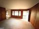 Spacious living room with classic wood paneling, neutral carpeting, and a welcoming front entrance at 359 Keys Ferry St, Mcdonough, GA 30253
