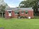 Back exterior view of a brick house with a spacious yard and green awning accents at 359 Keys Ferry St, Mcdonough, GA 30253