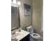 Cozy bathroom with a framed mirror above a blue vanity, white sink, and toilet at 4230 Vinca Way, Union City, GA 30291