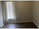 Simple bedroom featuring a window with curtains, fresh paint, and hardwood flooring at 4230 Vinca Way, Union City, GA 30291