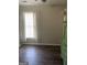 Neutral bedroom featuring a window with blinds and curtains, hardwood floor, and green dresser at 4230 Vinca Way, Union City, GA 30291