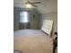 Spacious carpeted bedroom featuring a ceiling fan and a window for natural light at 4230 Vinca Way, Union City, GA 30291