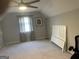 Spacious carpeted bedroom featuring a ceiling fan and a window for natural light at 4230 Vinca Way, Union City, GA 30291