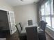 This dining room features hardwood flooring, a large window and a glass table at 4230 Vinca Way, Union City, GA 30291