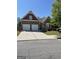 Charming two-story home with a two-car garage and beautifully landscaped front yard on a sunny day at 4230 Vinca Way, Union City, GA 30291