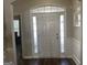 Bright foyer featuring a white front door with sidelights and transom window, and dark wood flooring at 4230 Vinca Way, Union City, GA 30291