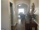 Hallway leading to a living area with archway, hardwood floors, and decorative accents on a console table at 4230 Vinca Way, Union City, GA 30291