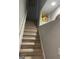 Carpeted stairway with white banister leading to the upper level of the home at 4230 Vinca Way, Union City, GA 30291