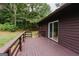 An outdoor wood deck with wood railings, perfect for relaxing with friends and enjoying the surrounding nature at 134 Ashwood Dr, Waco, GA 30182