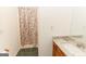 Bathroom featuring a shower with a floral curtain and a vanity with a marble countertop at 134 Ashwood Dr, Waco, GA 30182