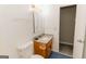 A well-lit bathroom featuring a vanity, toilet, and a mirror with a cabinet at 134 Ashwood Dr, Waco, GA 30182