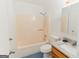 Clean bathroom with granite vanity, peach tub and shower combo, and blue tile floors at 134 Ashwood Dr, Waco, GA 30182