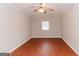 Bedroom featuring hardwood floors, ceiling fan, and window bringing in natural light at 134 Ashwood Dr, Waco, GA 30182