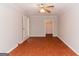 Spacious bedroom with ceiling fan, hardwood floors and two entryways at 134 Ashwood Dr, Waco, GA 30182