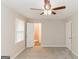 Bedroom with plush carpeting, ceiling fan, and bathroom access at 134 Ashwood Dr, Waco, GA 30182