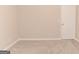 Neutral bedroom featuring plush carpeting, neutral walls, and a door at 134 Ashwood Dr, Waco, GA 30182