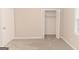 Bedroom featuring neutral walls, plush carpeting, and a closet with louvered doors at 134 Ashwood Dr, Waco, GA 30182