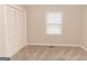 Bright bedroom with natural light, carpeted floors, and a closet with louvered doors at 134 Ashwood Dr, Waco, GA 30182