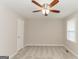 Neutral bedroom featuring plush carpeting, ceiling fan, and natural light from the window at 134 Ashwood Dr, Waco, GA 30182