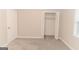 Bedroom featuring plush carpeting, closet and neutral walls at 134 Ashwood Dr, Waco, GA 30182