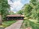 Charming single-story home with a welcoming front porch, long driveway, and lush green lawn at 134 Ashwood Dr, Waco, GA 30182