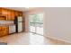 Kitchen featuring stainless steel appliances, tile flooring, and sliding glass doors to a backyard deck at 134 Ashwood Dr, Waco, GA 30182
