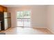 Kitchen featuring stainless steel refrigerator, tile flooring, and sliding glass doors to back deck at 134 Ashwood Dr, Waco, GA 30182