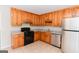 Well-lit kitchen features wood cabinets and stainless appliances at 134 Ashwood Dr, Waco, GA 30182