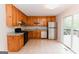 Kitchen features wood cabinets, stainless appliances, and sliding door to the deck at 134 Ashwood Dr, Waco, GA 30182