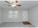 Carpeted living room featuring neutral paint, bright ceiling fan and front door at 134 Ashwood Dr, Waco, GA 30182