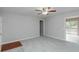 Carpeted living room with neutral walls, bright ceiling fan and sliding glass doors to deck at 134 Ashwood Dr, Waco, GA 30182