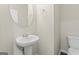 Half bathroom featuring a pedestal sink and toilet at 5768 Grande River Rd, Atlanta, GA 30349
