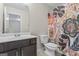 Bathroom with marble countertops, toilet, and floral shower curtain at 5768 Grande River Rd, Atlanta, GA 30349