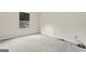 Bedroom with gray carpeting, window with view of neighborhood at 5768 Grande River Rd, Atlanta, GA 30349