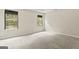 Bright bedroom with gray carpeting and two windows at 5768 Grande River Rd, Atlanta, GA 30349