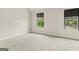 Neutral bedroom with two large windows and carpet at 5768 Grande River Rd, Atlanta, GA 30349