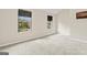 Bright bedroom featuring neutral walls, gray carpeting, and natural light from two windows at 5768 Grande River Rd, Atlanta, GA 30349