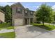 Charming two-story home with a brick and gray siding exterior and attached one car garage at 5768 Grande River Rd, Atlanta, GA 30349