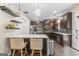 Eat-in kitchen featuring stainless appliances, granite counters, and dark wood cabinetry at 5768 Grande River Rd, Atlanta, GA 30349