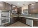Kitchen showcasing stainless appliances, granite counters, and dark wood cabinetry at 5768 Grande River Rd, Atlanta, GA 30349