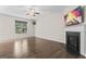 Bright living room featuring hardwood floors, fireplace and ceiling fan at 5768 Grande River Rd, Atlanta, GA 30349