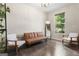 Bright living room with hardwood floors, neutral walls, a window view, and stylish modern decor at 5768 Grande River Rd, Atlanta, GA 30349