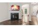 Living room featuring a cozy fireplace, archway to entry and hardwood floors at 5768 Grande River Rd, Atlanta, GA 30349