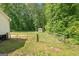 Large back yard featuring a shed and bordered by trees at 180 E Ranchette Rd, Temple, GA 30179